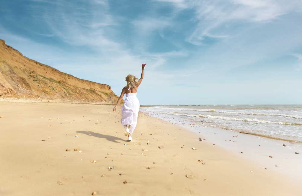 lady in a white dress on the beach