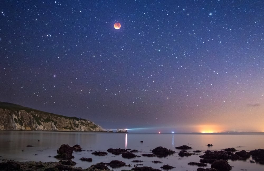 supermoon eclipse above alum bay and the needles