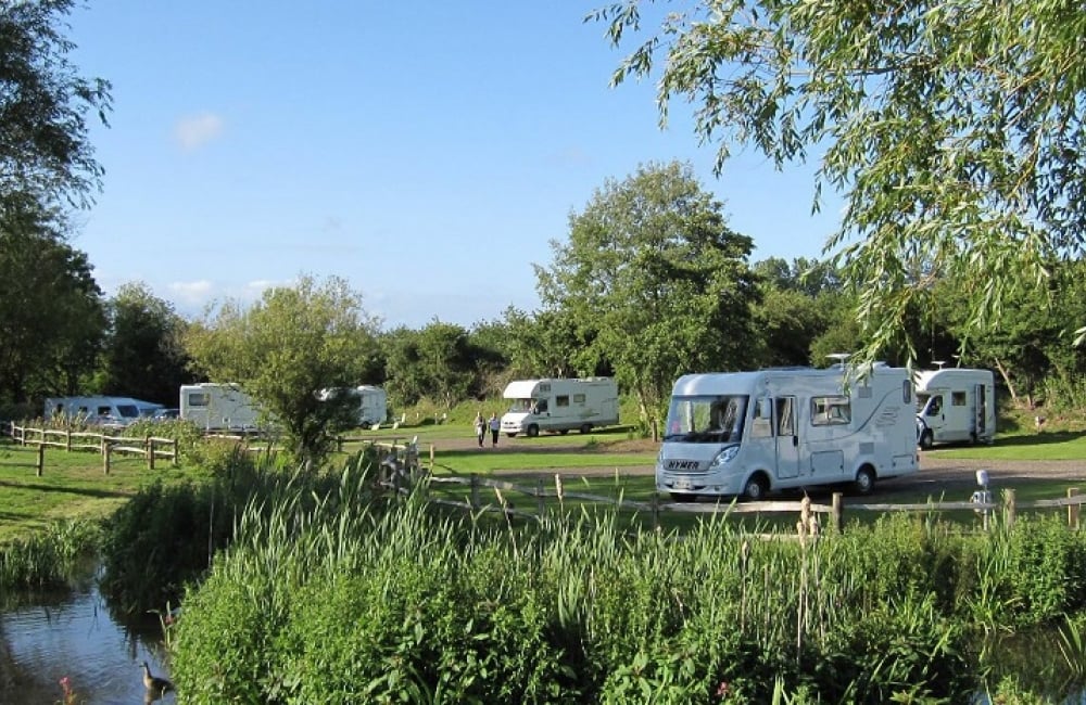 Appuldurcombe Gardens Bluebell Meadow showing motorhomes and the stream