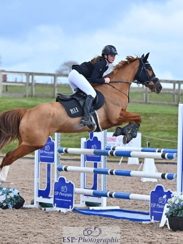 Rubi with Maverick XXI jumping a hurdle