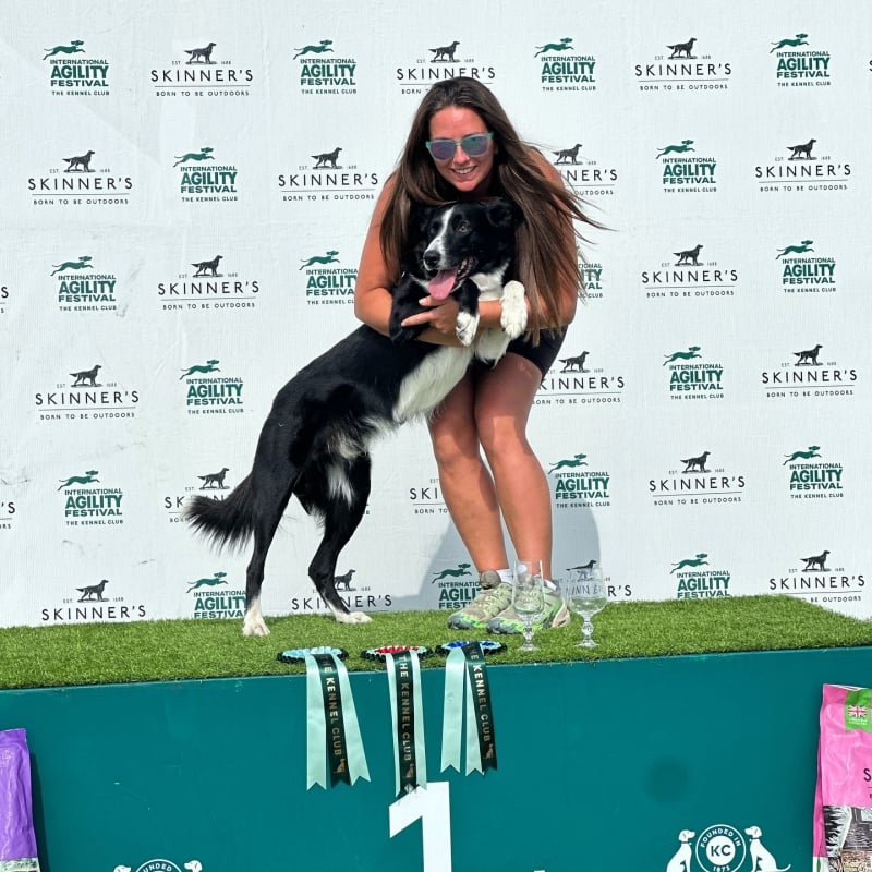abs and dog dash pose atop the podium